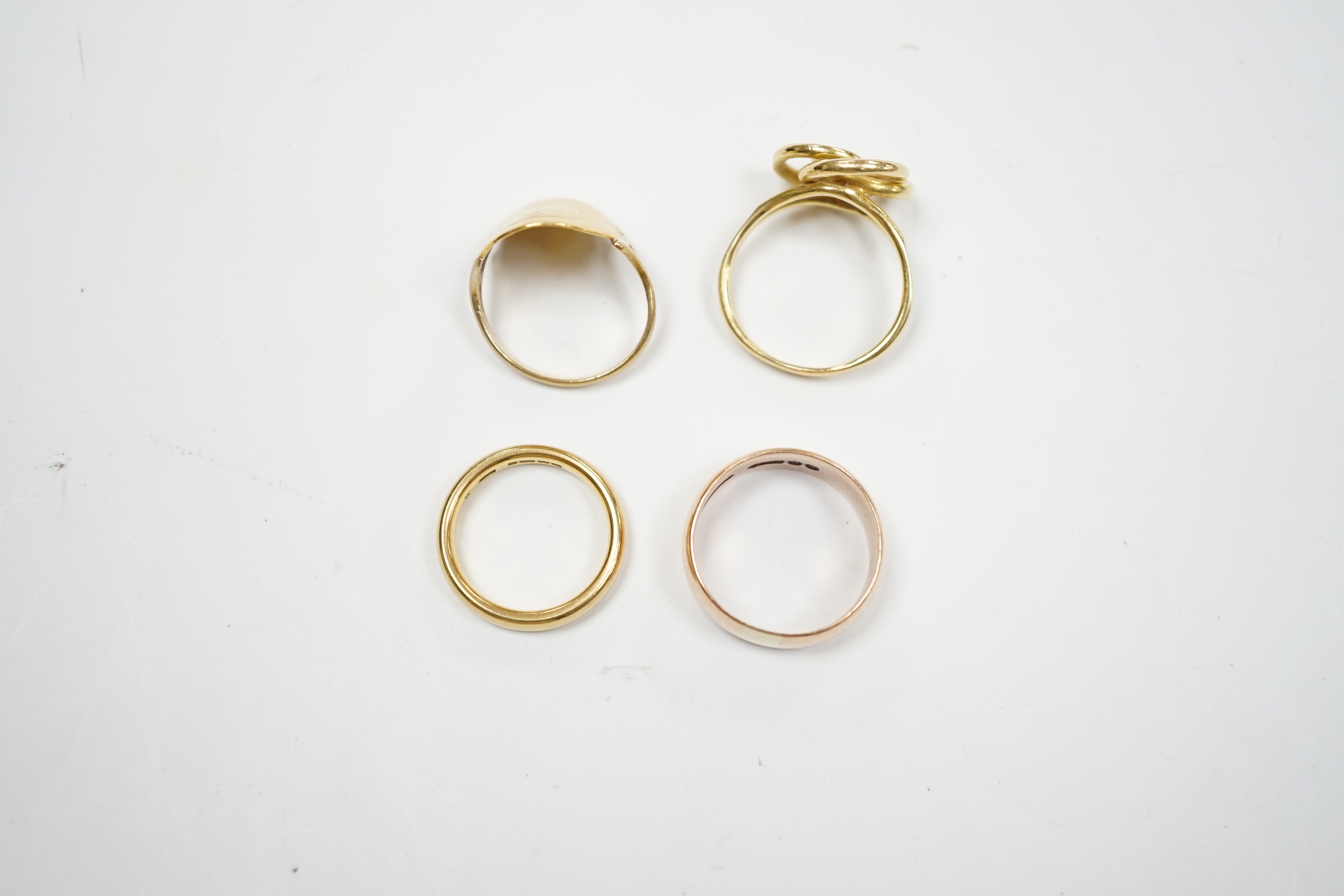 A 1930's 22ct gold wedding band, 5.9 grams, a 9ct gold wedding band, 5.1 grams and two other yellow metal rings, 10.1 grams.